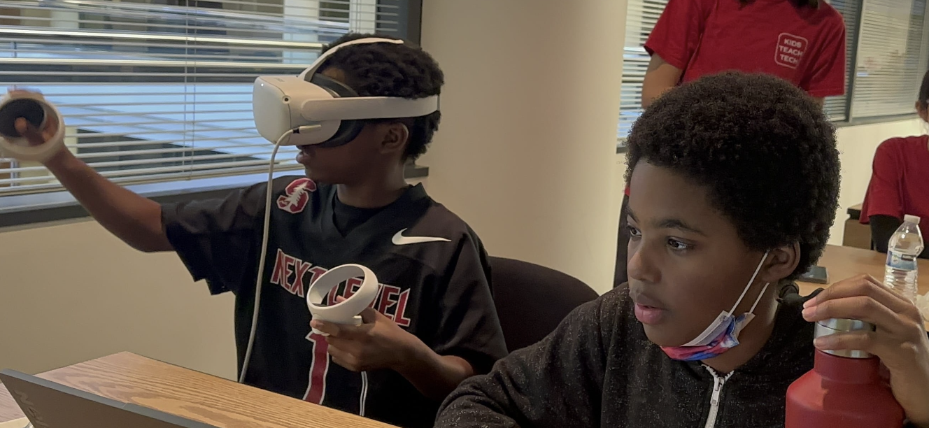 Slide Image - students and team posing infront of comcast headquarters